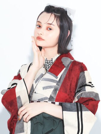 着物と袴のレンタルセット商品画像。袴はブルーグレー色。着物は赤色。蕾花柄のデザイン。上半身アップ画像。